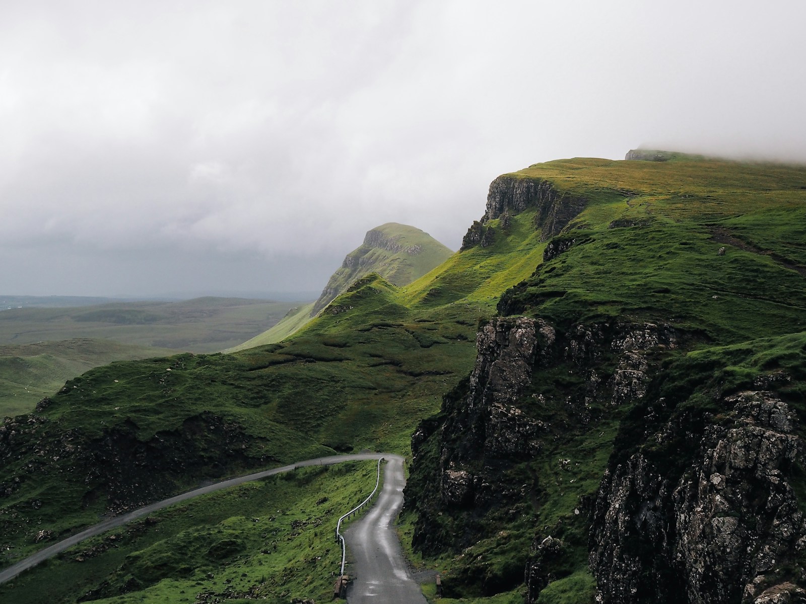 concrete road between mountains